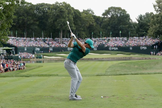 Golfer teeing off